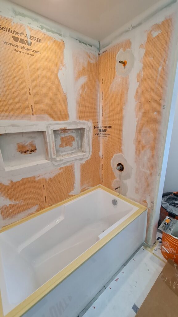 Waterproofing and new bathtub installation during the bathroom renovation